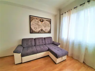 a purple couch in a room with a window at Epstein Apartments in Prague