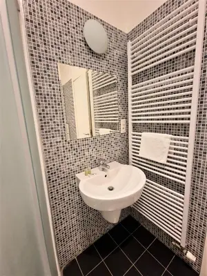 a bathroom with a sink and a mirror at Reznicka Apartments in Prague