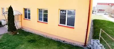 a house with three windows on the side of it at Apartmán Topolová 912B in Milovice