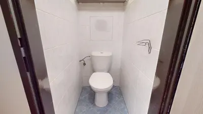 a small bathroom with a toilet in a stall at Apartmán Topolová 912B in Milovice
