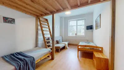 a room with a bunk bed and a ladder at Apartmán Topolová 912B in Milovice