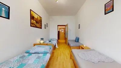 a room with two beds and a hallway at Apartmán Topolová 912B in Milovice