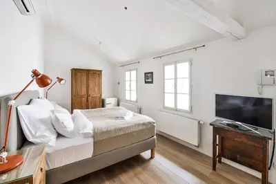 a bedroom with a bed and a flat screen tv at COZY QUIET STUDIO AT CHARLES BRIDGE in Prague
