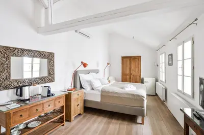 a bedroom with a bed and a dresser with a mirror at COZY QUIET STUDIO AT CHARLES BRIDGE in Prague