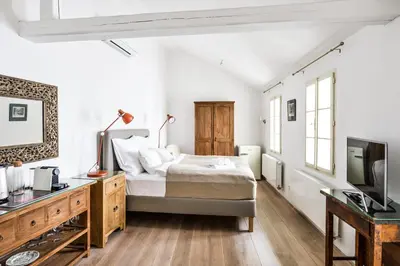 a bedroom with a bed and a desk and a tv at COZY QUIET STUDIO AT CHARLES BRIDGE in Prague
