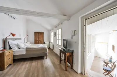 a bedroom with a bed and a desk and a television at COZY QUIET STUDIO AT CHARLES BRIDGE in Prague