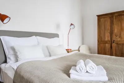 a bedroom with a bed with towels on it at COZY QUIET STUDIO AT CHARLES BRIDGE in Prague