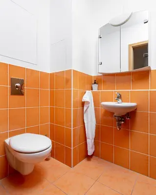 a white washing machine in a blue tiled room at Prague Days - Two-bedroom Family Apartment with Terrace and Garage in Vinohrady in Prague
