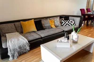 a living room with a couch with pillows on it at Prague Days - Two-bedroom Family Apartment with Terrace and Garage in Vinohrady in Prague