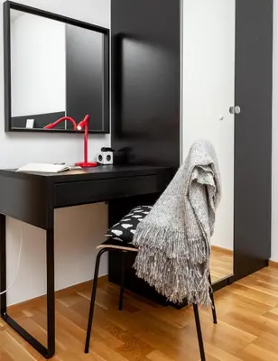 a living room with a red accent wall at Prague Days - Two-bedroom Family Apartment with Terrace and Garage in Vinohrady in Prague