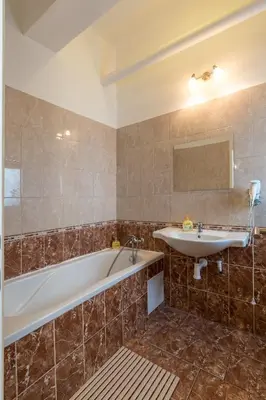 a bathroom with a tub and a sink at Apartman Exclusive Prague in Prague