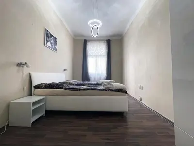 a bedroom with a bed and a window at Apartman Exclusive Prague in Prague