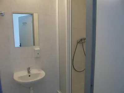a bathroom with a sink and a shower with a mirror at Hotel Hasa in Prague