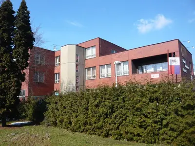 a building on a hill with bushes in front of it at Hotel Hasa in Prague
