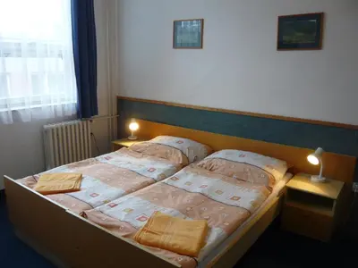 a bedroom with a bed with two pillows on it at Hotel Hasa in Prague