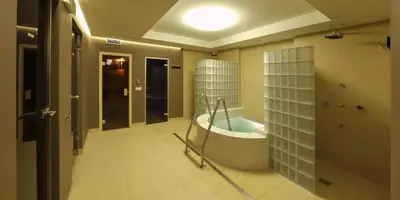 a bathroom with a tub in the middle of a room at Esmarin wellness hotel in Mníšek pod Brdy