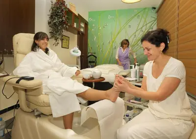 a woman sitting in a dentist chair with a patient at Esmarin wellness hotel in Mníšek pod Brdy