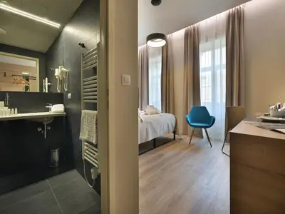 a room with a bedroom with a bed and a bathroom at EA Hotel New Town in Prague