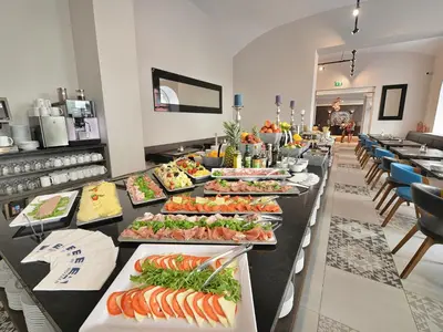 a buffet line with many different types of food at EA Hotel New Town in Prague
