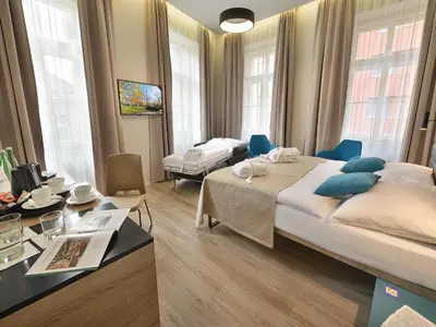 a bedroom with a large bed and a desk at EA Hotel New Town in Prague