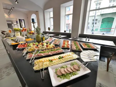 a buffet line with many plates of food at EA Hotel New Town in Prague