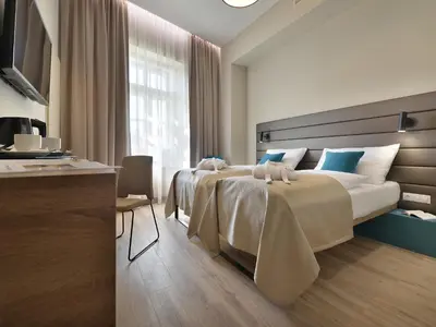 a hotel room with two beds and a window at EA Hotel New Town in Prague