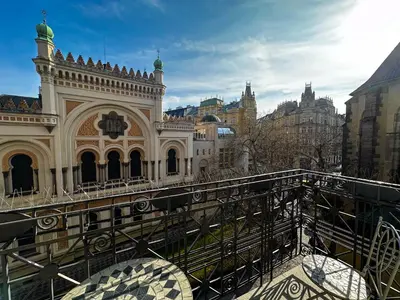 a building with a bridge in front of a building at Gold Art Apartments in Prague