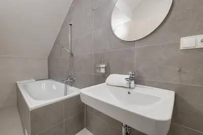 a silver chandelier hanging in front of a mirror at Gold Art Apartments in Prague
