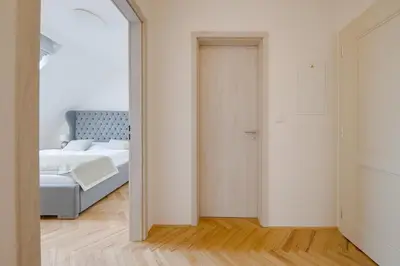 a bedroom with a large bed and a window at Gold Art Apartments in Prague