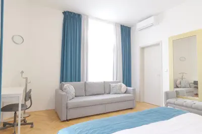 a living room with a staircase and a couch at Gold Art Apartments in Prague