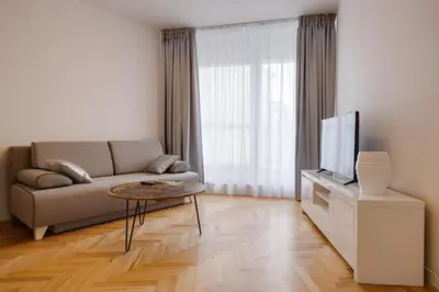 a living room with a couch and a desk at Gold Art Apartments in Prague