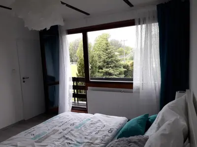 a bedroom with a bed and a large window at Apartment 144 in Kněževes