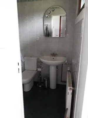 a bathroom with a sink and a toilet and a mirror at Apartment 144 in Kněževes