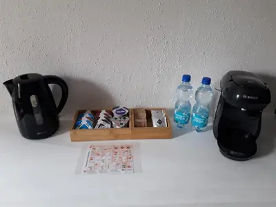 a table with a coffee maker and two bottles of water at Apartment 144 in Kněževes