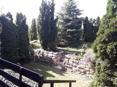 a bench sitting next to a stone wall at Apartment 144 in Kněževes