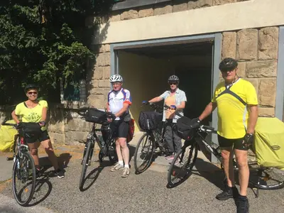 a group of people standing with their bikes outside a building at Pension Karnet in Prague