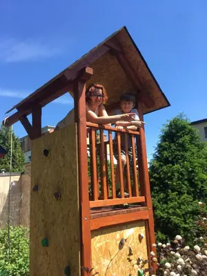 a woman and a child in a play structure at Pension Karnet in Prague