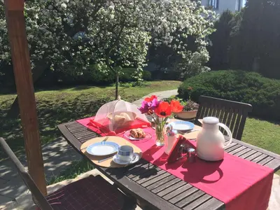 a picnic table with a plate of food and flowers on it at Pension Karnet in Prague