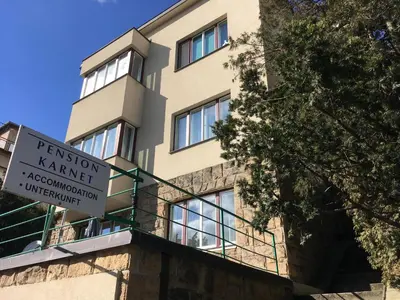 a building with a sign in front of it at Pension Karnet in Prague