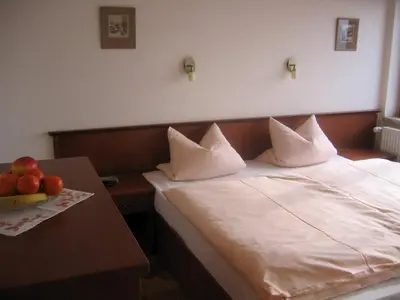 a bedroom with a bed and a table with fruit on it at Pension Apartment Granit in Prague