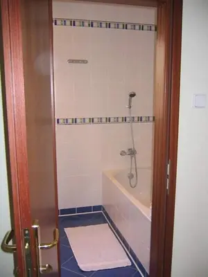 a bathroom with a shower with a tub and a sink at Pension Apartment Granit in Prague