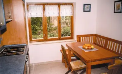 a kitchen with a table and a table and a window at Pension Apartment Granit in Prague
