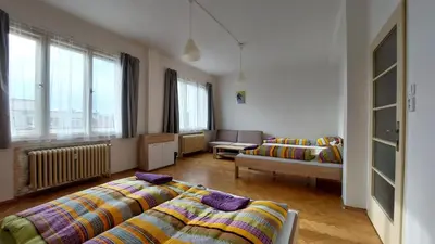 a living room with two beds and a couch at Bonvolon in Prague
