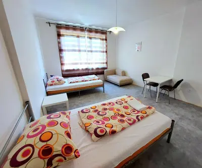 a kitchen with white cabinets and a counter top at Bonvolon in Prague