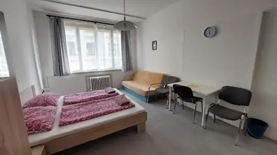 a bathroom with a tub and a toilet and a sink at Bonvolon in Prague