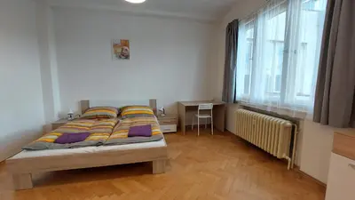 a living room with a couch and a table at Bonvolon in Prague