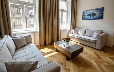 a living room with two couches and a coffee table at Letna Garden Suites in Prague