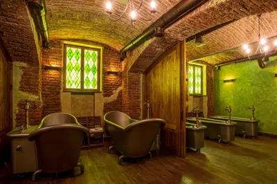 a bathroom with a bunch of urinals and sinks at Letna Garden Suites in Prague