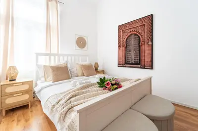 a white room with two beds and a tv at Celine Prague Hostel in Prague