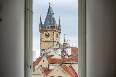a white room with white beds and a window at Celine Prague Hostel in Prague